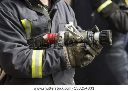 Firefighter holding fire hose