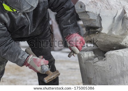 Sculptor Working On A Large Stone Sculpture