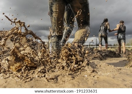 Mud race runner\'s muddy feet