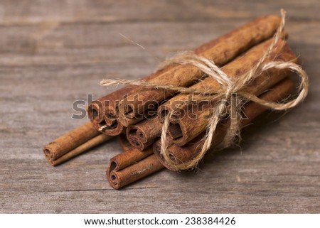 Cinnamon sticks close up on wooden background