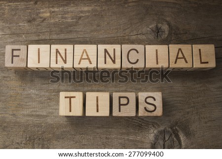 Financial tips text on a wooden background