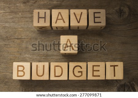 Have a budget on a wooden background