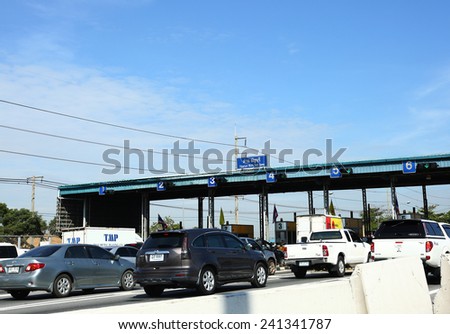 Thanya Buri Toll Gate-DECEMBER 6: Vehicles line up at the toll both of a highway on December 6, 2014 in Thailand. People use the service more than 5 million cars and 2,000 cars are added each month.