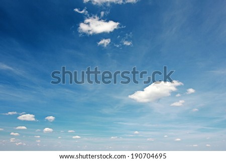 Blue sky. White clouds in a blue sky. Blue sky background with tiny clouds