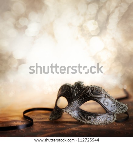 female carnival mask with glittering background