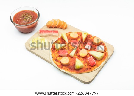Italian pizza making process : Topping sausage, pineapple and crab stick on pizza dough [isolated white background]