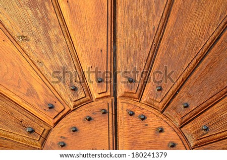 A section of an ancient studded door with wood panels