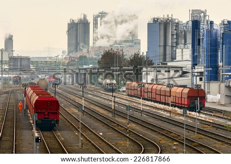 Image showing trains against an industrial background with factories pumping coal fumes into the atmosphere