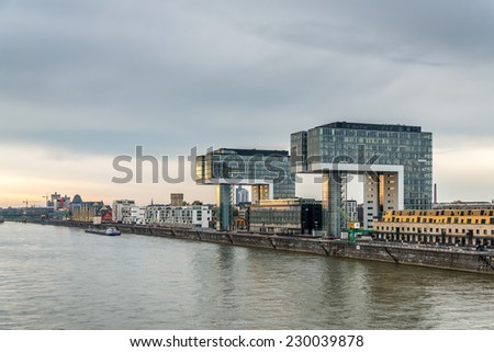 A moody riverside image of architecture on the banks of the river rhine in germany