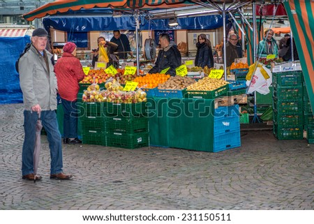 BONN, GERMANY NOVEMBER 15 2014 - Unidentified persons shopping at the weekly market held every saturday in Bonn Marktplatz