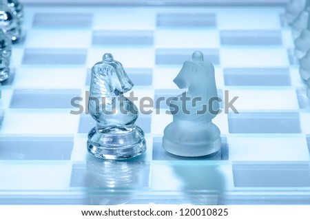 Two glass chess horse faced, clear glass and frosted glass