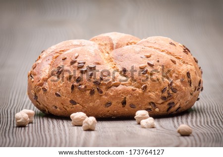 Bread with seeds  on wood surface