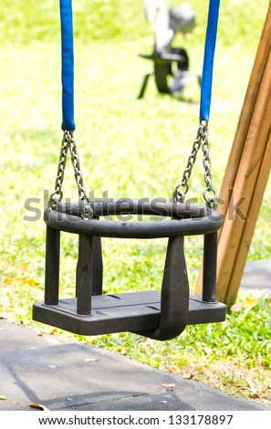 Close up of swing in a children play area at park.