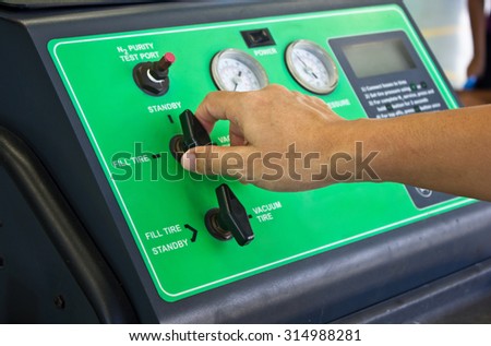 Man\'s Hand Working With Nitrogen Tire Filling System Machine.