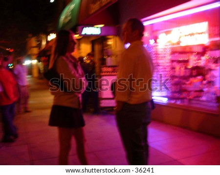 Woman and man talking on the street in Santa Monica outside a bar / nightclub.