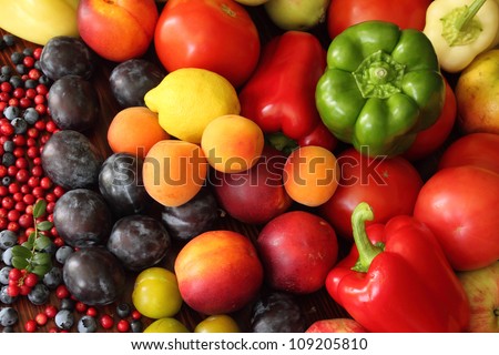 Ripe vegetables and fruits. Organic produce. Tomatoes,  plums, pepper, cowberries, apples and other food.