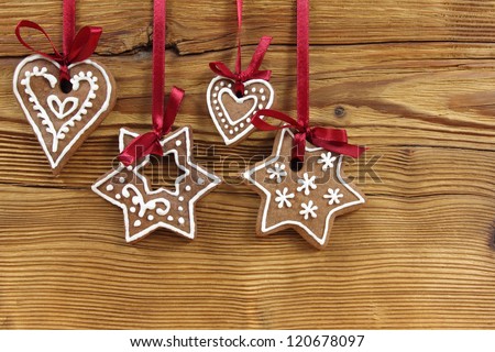 Gingerbread cookies hanging on wooden background. Christmas decoration.