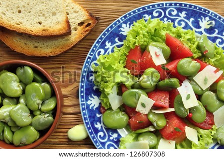 Close up of a broad beans salad with tomato and goat cheese