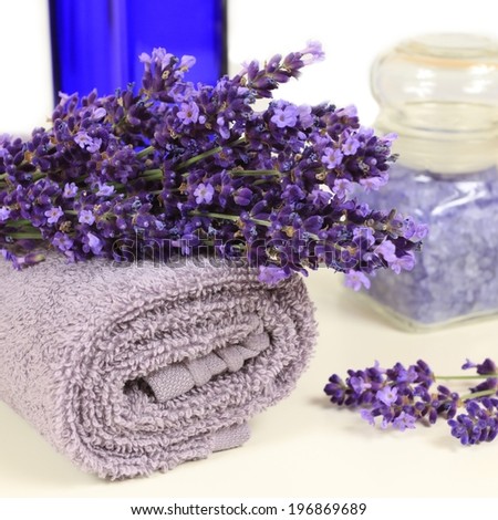 Relaxing spa resort composition - towels, lavender flower, bottle with salt.