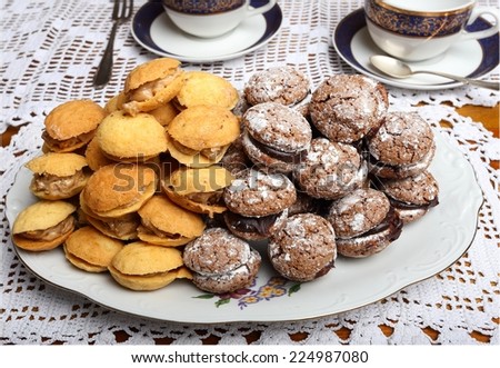 Plate of cookies filled chocolate and walnut cream