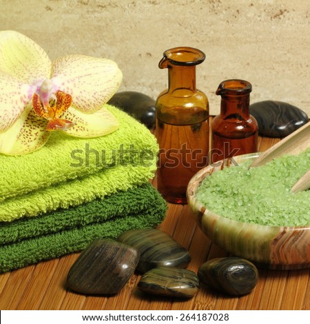 Relaxing spa resort composition -  towels, orchid flower, bottles of essential oil