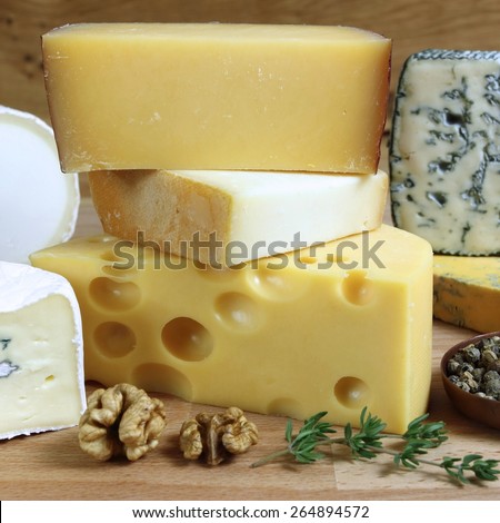 Cheese board - various types of soft and hard cheese. International dairy delicacies.