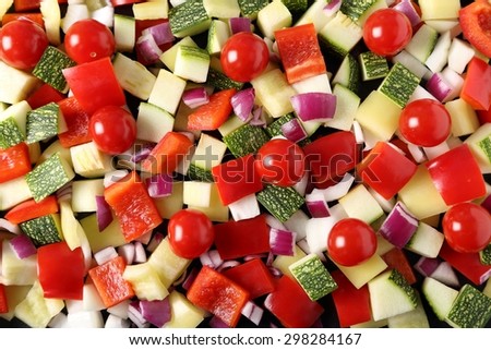 Colored peppers and onions diced on a chopping board.
