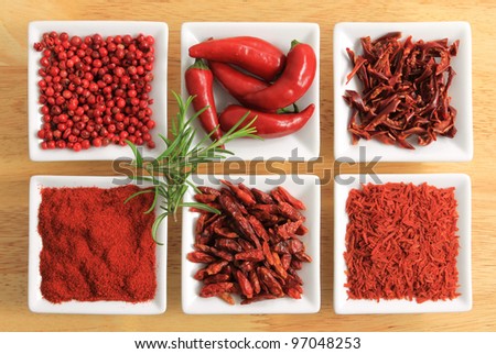 Red spices - chili peppers, ground pepper, pepper powder, dried tomatoes.