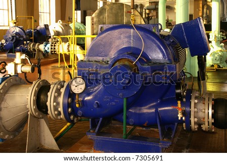 Water pumping station - industrial interior and pipes.