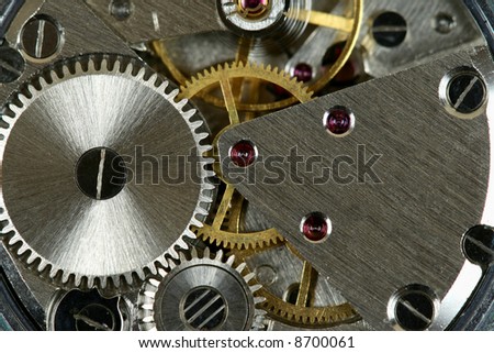 Small watch mechanism close-up. Steel clock works.
