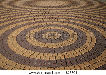Concentric circular rings made of stone tiles. Town square.