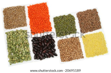 All sorts of beans and cereals sorted in white ceramic containers. Decorative and colorful food abstract.