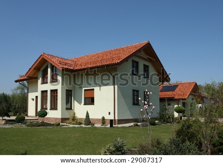 New single family home with red slate roof and garden