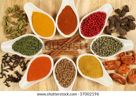 Whole variety of colorful spices. Assortment of cuisine ingredients in ceramic containers.