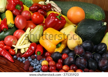 Autumn harvest - ripe fruit and vegetables. Organic produce. Tomatos, plums, raspberries, zucchini, pears and other food.