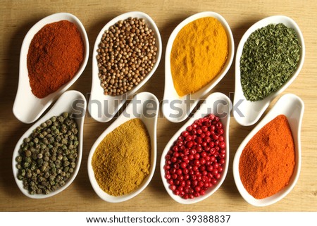 Whole variety of colorful spices. Assortment of cuisine ingredients in ceramic containers.