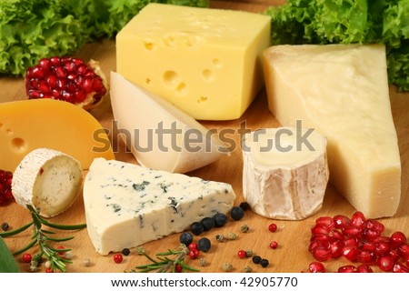 Board of cheese: gouda, ementaler, Danish blue soft cheese and other hard cheeses. Herbs and spices.