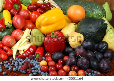 Organic food products. Autumn harvest - ripe vegetables and fruits. Tomatoes, beans, plums, pepper, raspberries, zucchini, pears and other food.