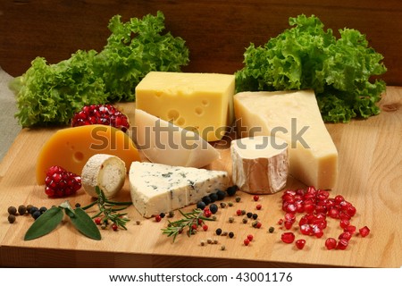 Selection of cheese: gouda, ementaler, Danish blue soft cheese and other hard cheeses. Herbs and spices.