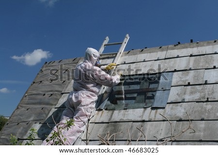 Asbestos removal worker. Dangerous waste disposal - professional works with old architecture.