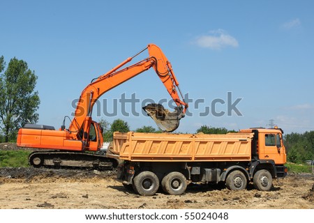 Motorway construction works in Poland. Heavy machinery - excavator and dump truck.
