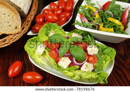 Fresh cherry tomatoes salad with seasoned mozzarella cheese, arugula and green lettuce