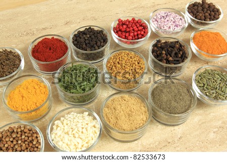 Cuisine ingredients - herbs and spices. Food additives in glass bowls.