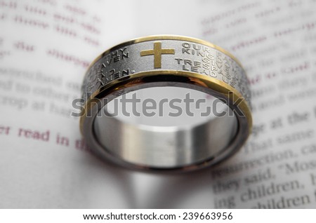 Lord\'s Prayer steel ring in a Bible