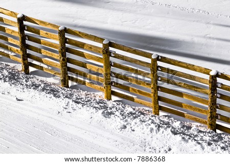 wooden fence on the snow