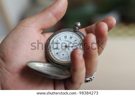antique watch in a senior men\'s  hand