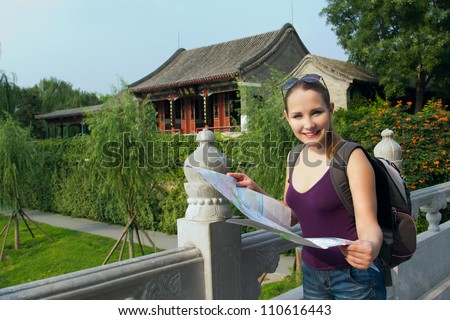 Caucasian woman with map and backpack travel in China. Student travel during summer holiday