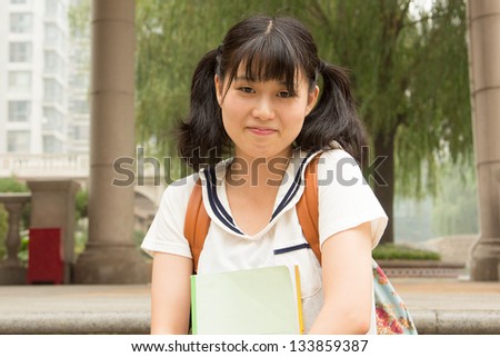 Student asian girl outside in summer green park smiling happy. Female college or university student holding books