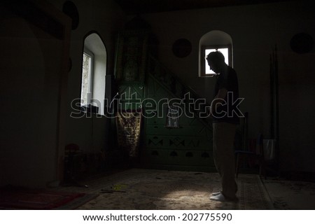 Time for prayer/Muslim man having his prayer in a small wooden mosque in the village of Lukomir during the holy month of Ramadan. Lukomir, Bosnia and Herzegovina,  July 14, 2013.
