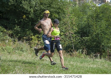 Ramnicu Valcea, Romania, August 30, 2015. Couple running/ Man and woman running together during the cross trail competition within Oltenia's Marathon event.